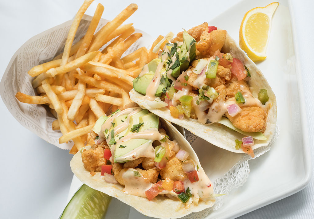 Fish tacos with creamy sauce and fresh ingredients from The Longwood Grille and Bar