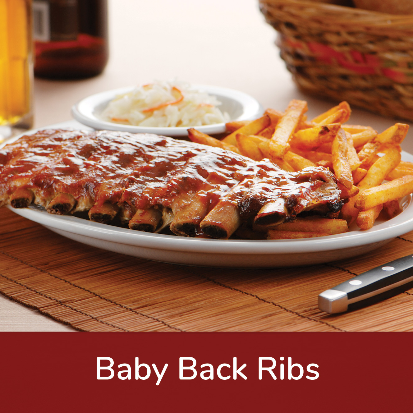 Plate of baby back ribs, fries, and slaw with text underneath that reads, 'Baby Back Ribs'
